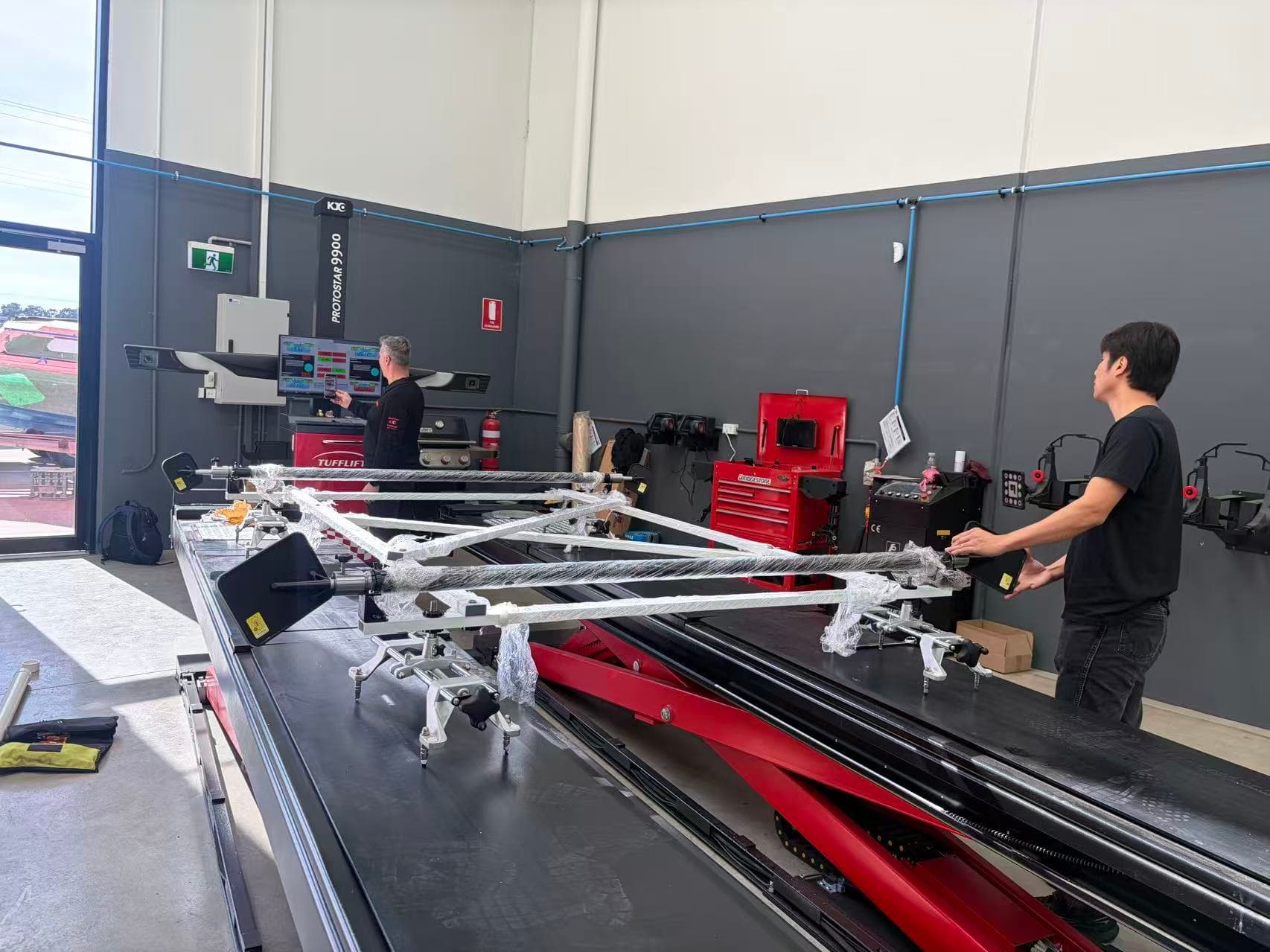 David Li and Marco Iannelli conducting a wheel aligner calibration demonstration in Epping, Australia